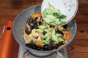 Return the cooked pork and eggs to the pan. Toss briefly. Add the cucumber slices last (to keep them crisp). Add 1 tablespoon oyster sauce and 1 tablespoon light soy sauce around the perimeter of the wok to sear the sauce. Taste and add a pinch of salt if needed.