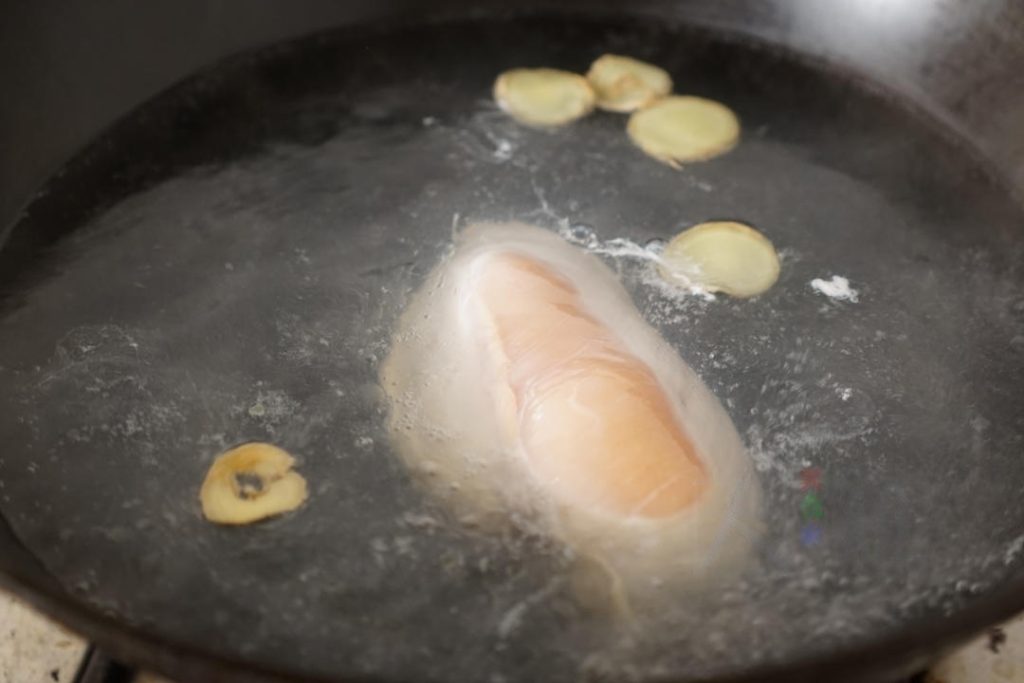 Place the chicken breast and ginger slices into a pot of cold water.