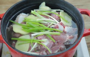 The Blanch: Place ribs in a pot of cold water with a few ginger slices and scallion whites.