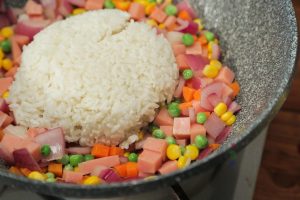 Fry the Rice: Add the cooked coconut rice to the wok. Use your spatula to break up any clumps.