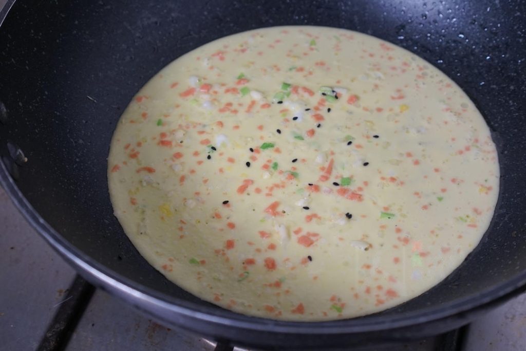 Pour and Swirl Using a ladle, pour about 1/4 to 1/3 cup of batter (depending on pan size) into the center of the pan.