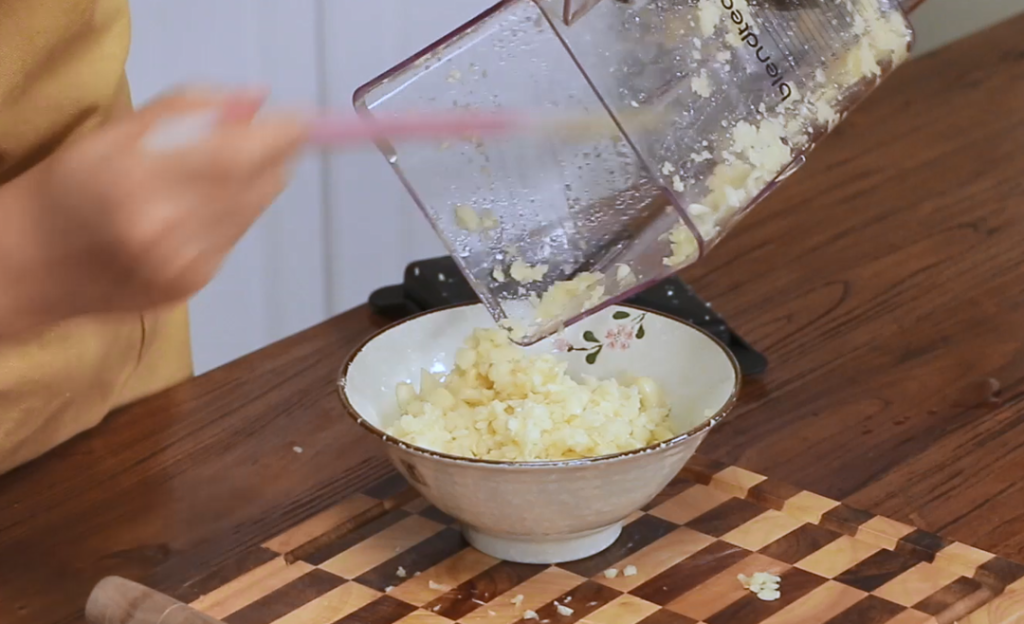 Mince the 8 heads of garlic. You can smash and chop them by hand, pound them in a mortar and pestle, or pulse them in a food processor on low speed. You want a coarse mince.