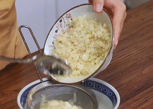 Divide your minced garlic into two equal portions. Take one portion and place it in a fine-mesh sieve. Rinse it thoroughly under cool running water.