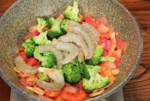 Combine and Braise Add the shrimp meat and the blanched broccoli to the pan. Stir to coat them in the tomato mixture. Pour in enough water to sit just level with the ingredients (do not drown them). Bring to a boil.