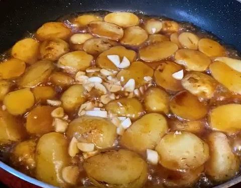 Braise (3–5 minutes): Add half a small bowl (about 1/4 cup or 60 ml) of water to the pan. Turn the heat to medium-low and let it simmer until the water dries up and the sauce clings to the potatoes. Note: If your potatoes were cut too thickly and aren't fully soft yet, add a splash more boiling water and continue simmering.