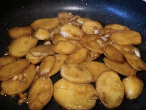 Braise (3–5 minutes): Add half a small bowl (about 1/4 cup or 60 ml) of water to the pan. Turn the heat to medium-low and let it simmer until the water dries up and the sauce clings to the potatoes. Note: If your potatoes were cut too thickly and aren't fully soft yet, add a splash more boiling water and continue simmering.