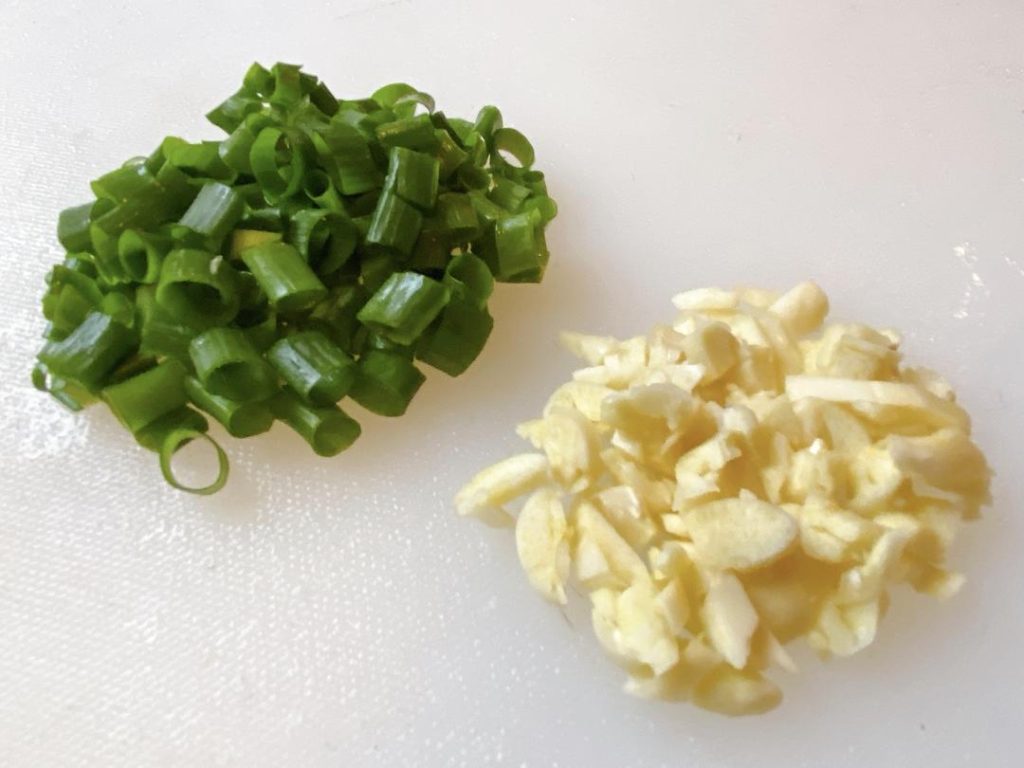 Aromatics: Cut the scallions into small sections (separating whites and greens) and finely mince the garlic.