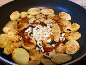 Seasoning: When both sides are golden brown, add the minced garlic (and chilis if using). Pour in the Shaoxing wine, light soy sauce, oyster sauce, and a small pinch of salt.