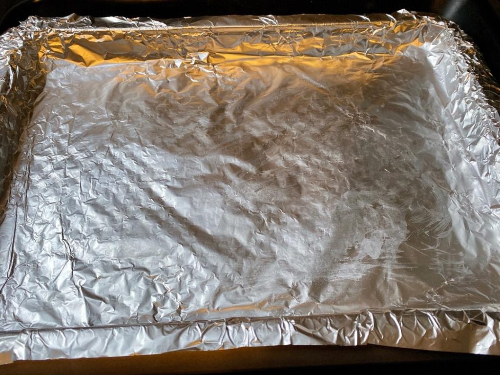 Prepare the Roasting Pan: Preheat your oven to 220°C (430°F) for 10 minutes. Line your roasting pan with aluminum foil. Toss the thick slices of potato and carrot with a little oil, salt, and pepper. Spread them out evenly on the foil, making sure there are no large gaps.