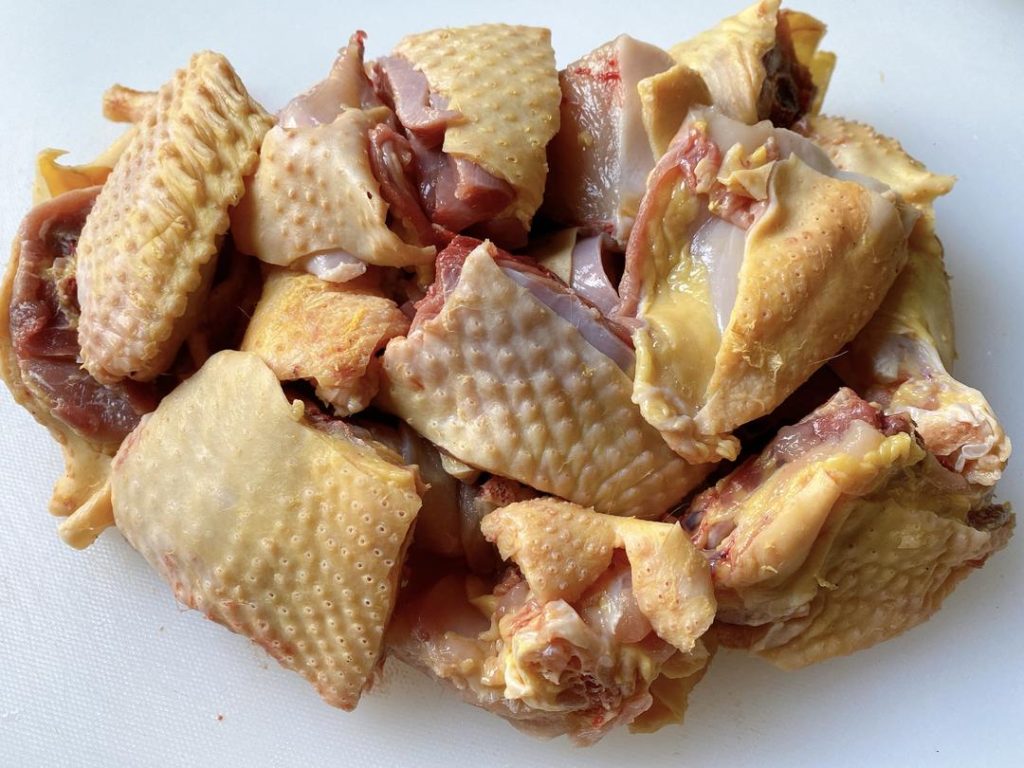 Chop the Chicken: If you are using a whole or half chicken, chop it through the bone into 1.5-inch (4 cm) pieces using a heavy meat cleaver. Bone-in chicken yields a much richer sauce due to the marrow and connective tissue.