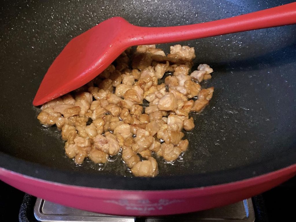 Sear the Pork (2–3 minutes): Heat 1 to 2 tablespoons of cooking oil in your wok over medium-high heat (around 350°F/175°C). Add the marinated pork and quickly stir-fry until the exterior changes color and is cooked through. Remove the pork from the wok and set it aside.