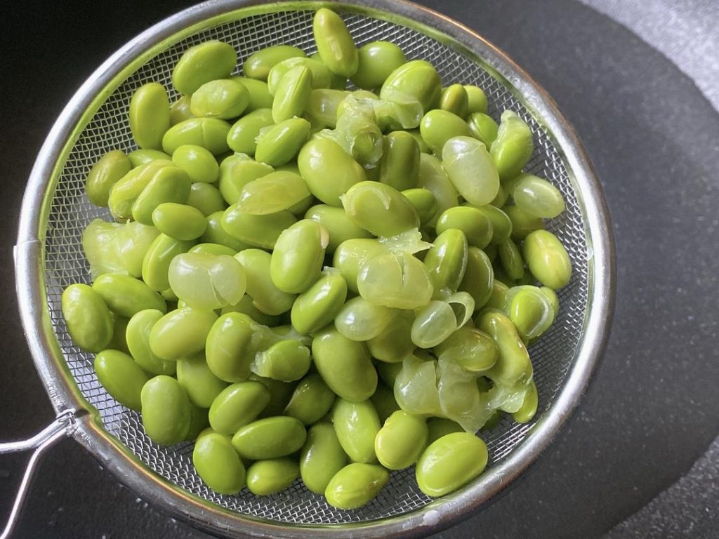 Boil the Beans (10 minutes): Place the green soybeans in a pot with cold water. Bring to a boil and cook for about 10 minutes until tender. (If using a pressure cooker or heavy-lidded pot, this time will be shorter). Drain well and set aside.