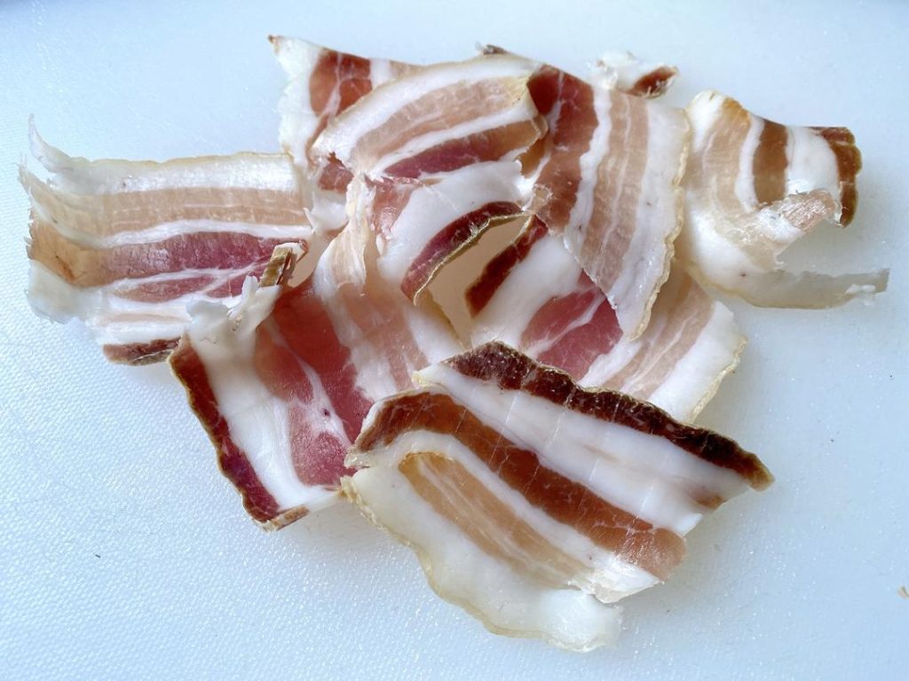 Assemble (5-10 minutes): Carefully tuck one thin slice of salted pork into each cut you made in the eel. Lay any remaining pork slices on top.