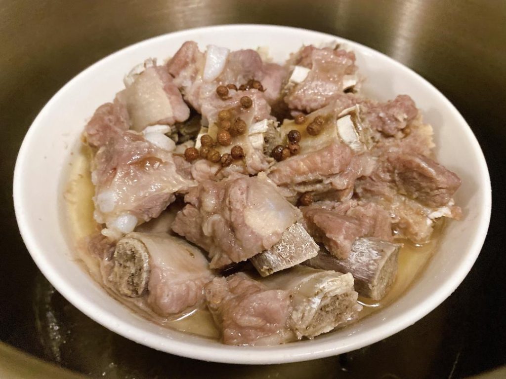 Steam (35 minutes): Place the dish in an electric pressure cooker or a steamer over high heat. Steam for about 35 minutes. The meat should shrink slightly from the bone. Ensure the pork reaches an internal temperature of 145°F (63°C). Serve immediately.