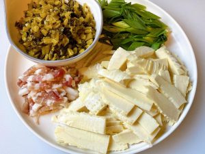 If your bamboo shoots are older or have green bottoms, blanch the slices in boiling salted water for 3-5 minutes, then drain well. If they are fresh and white, skip this step.