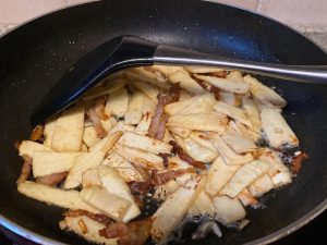 Fry the Bamboo Shoots (4–6 minutes): Add the remaining tablespoon of oil to the wok, then add the sliced bamboo shoots. Keep the heat at medium.