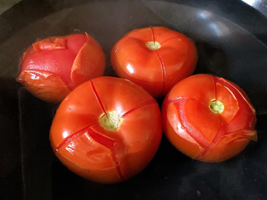 Prep the Tomatoes: Score an "X" on the bottom of each tomato. Blanch in boiling water for 60 seconds, then peel off the skin. Dice the tomatoes into small cubes. Mince your ginger and garlic.