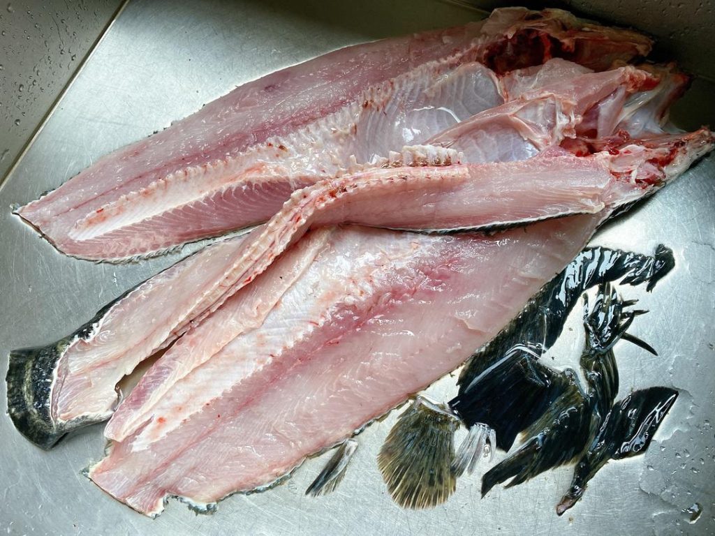 Fillet and Clean: Ask your fishmonger to fillet the fish and give you the bones, or do it yourself. Remove the ribs from the fillets and slice the meat at a 45-degree angle into 1/4-inch (6 mm) thick slices. Chop the fish bones into 2-inch chunks.