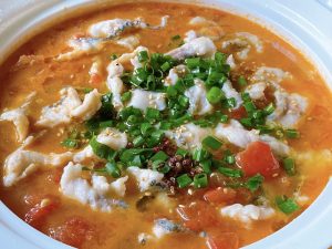 The Final Sizzle: Carefully transfer the fish and broth into your serving bowl over the bones. Top with scallions, sesame seeds, and Sichuan peppercorns. Heat 1 tbsp of oil in a small pan until smoking hot, then carefully pour it over the aromatics to release their essential oils.