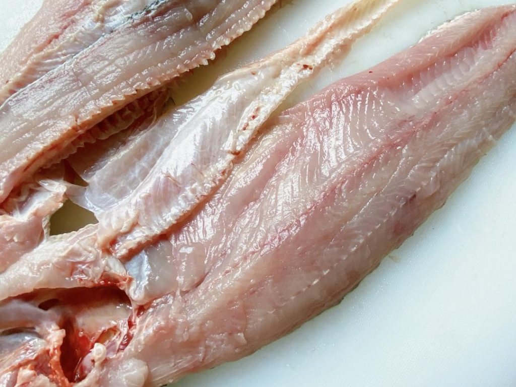 Fillet and Clean: Ask your fishmonger to fillet the fish and give you the bones, or do it yourself. Remove the ribs from the fillets and slice the meat at a 45-degree angle into 1/4-inch (6 mm) thick slices. Chop the fish bones into 2-inch chunks.
