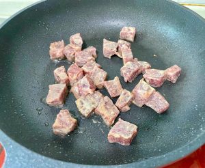 Cook the Beef: Immediately add the marinated beef cubes. Spread them into a single layer. Let them sear undisturbed for 30 seconds to develop a crust. Then, stir-fry swiftly for another 60 seconds until the exterior is browned but the inside is still slightly pink.
