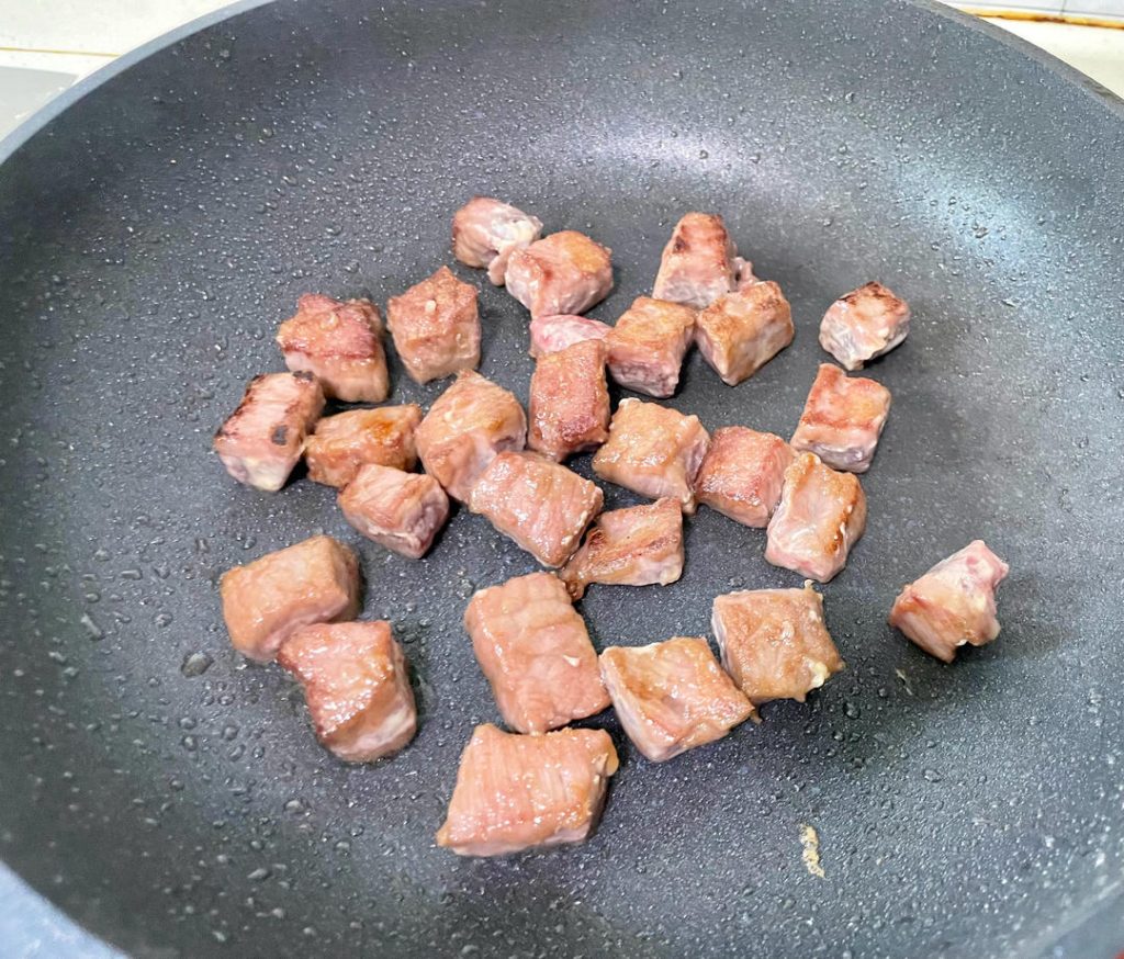 Cook the Beef: Immediately add the marinated beef cubes. Spread them into a single layer. Let them sear undisturbed for 30 seconds to develop a crust. Then, stir-fry swiftly for another 60 seconds until the exterior is browned but the inside is still slightly pink.