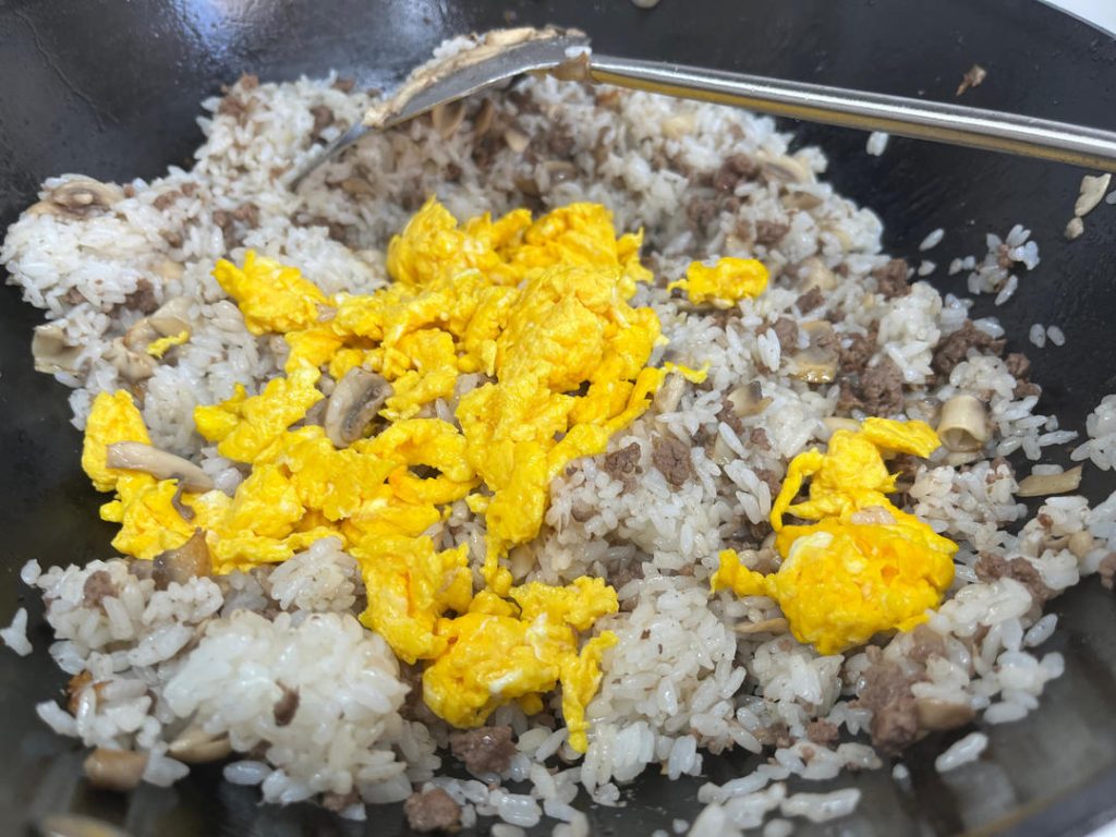 The Rice and The Return of the Egg Pour in the cold, day-old rice. Use your spatula to press down and break up any clumps, tossing it with the beef and mushrooms until the rice is hot and coated in that delicious beef tallow. Add the cooked eggs back in and toss to combine.