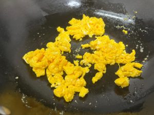 Scramble the Eggs Heat a wok or skillet over medium heat with 1 tablespoon of oil. Pour in the beaten eggs and scramble them quickly until just set but still soft. Remove them from the pan and set aside.