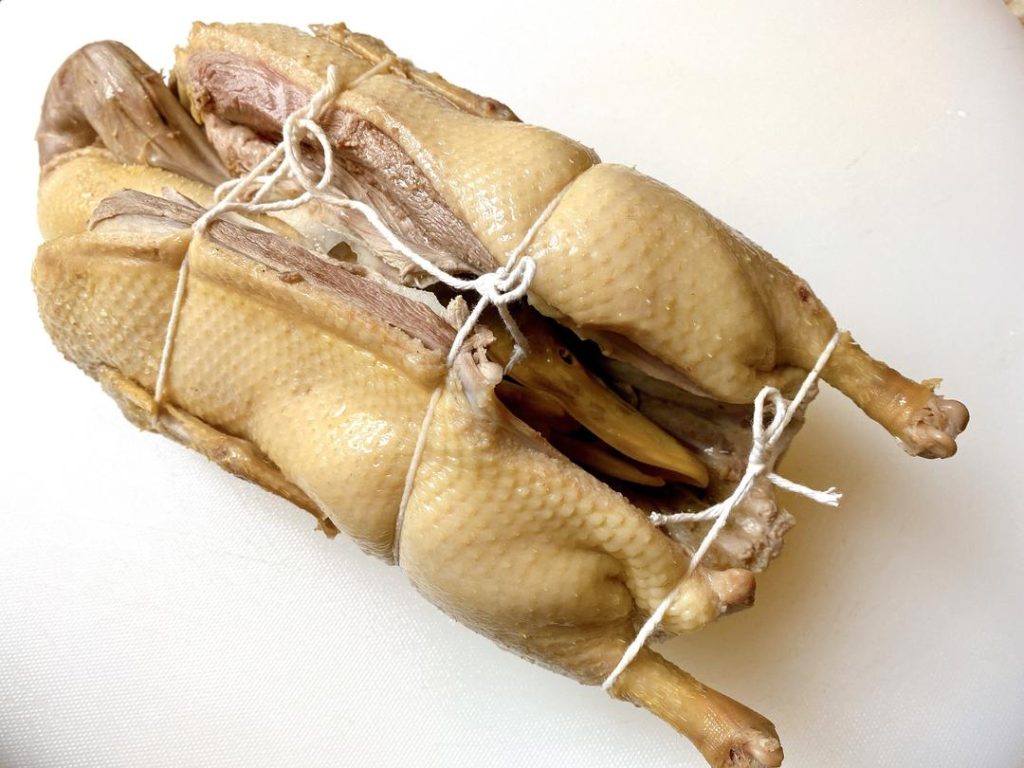 Trussing: Tucking the neck, head, and feet into the cavity and tying the duck with kitchen twine is critical. It ensures the duck maintains a beautiful shape and doesn't fall apart when it becomes fork-tender.