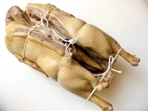 Trussing: Tucking the neck, head, and feet into the cavity and tying the duck with kitchen twine is critical. It ensures the duck maintains a beautiful shape and doesn't fall apart when it becomes fork-tender.