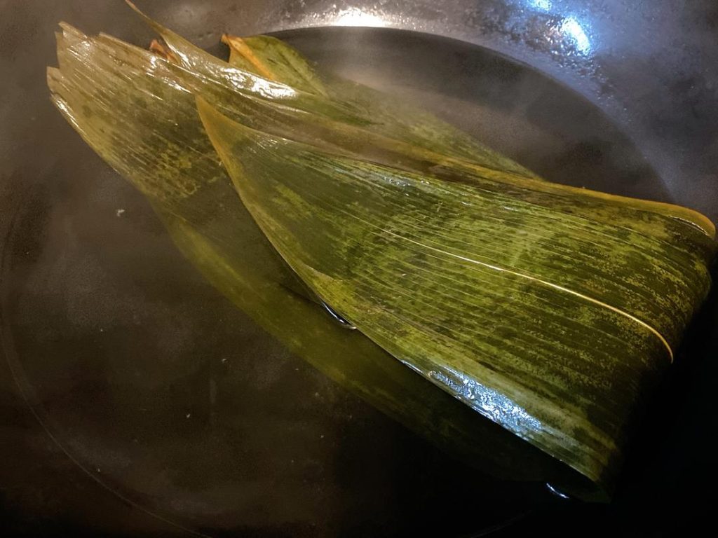 Soak the Leaves: Boil the bamboo leaves (Zong Ye) for 5 minutes until pliable, then rinse. This prevents the duck's skin from sticking to the bottom of the pot during the long braise.