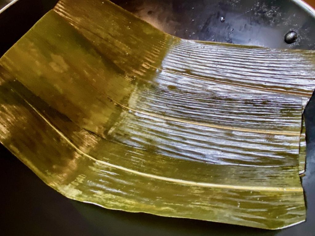 Prepare the Pot: Trim the ends off the softened bamboo leaves. Line the bottom of your empty, clean pot with them. Place the trussed duck directly on top of the leaves.