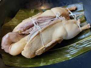 Prepare the Pot: Trim the ends off the softened bamboo leaves. Line the bottom of your empty, clean pot with them. Place the trussed duck directly on top of the leaves.