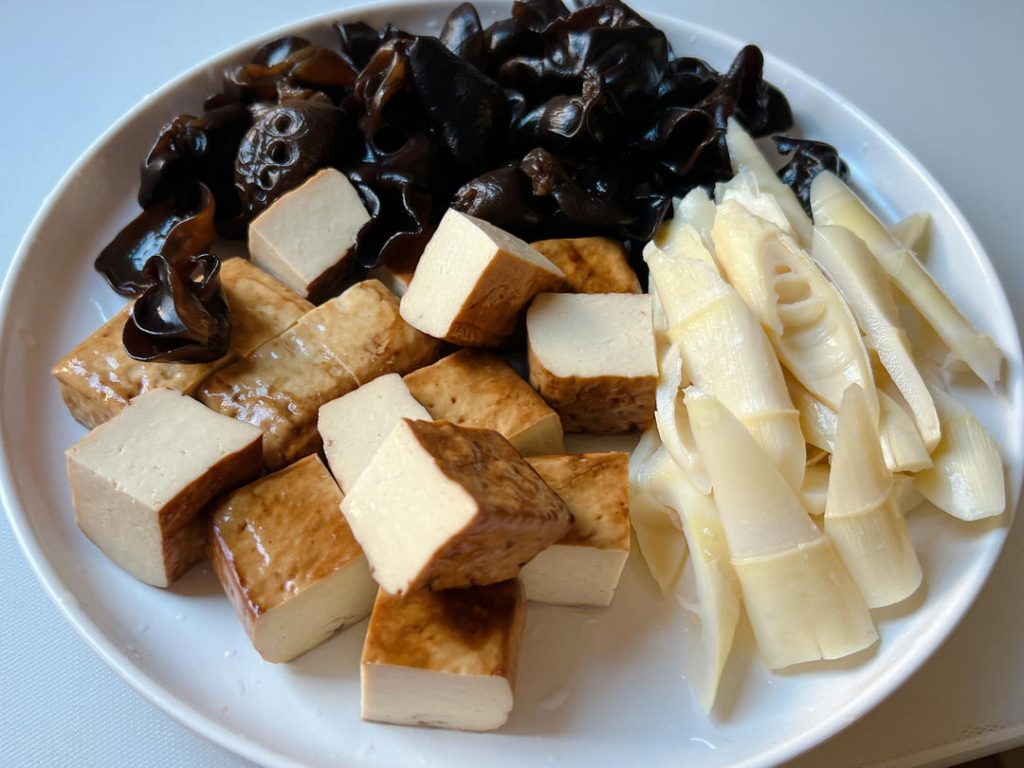 Hydrate the Mushrooms and Blanch the Bamboo: If using fresh bamboo shoots, slice them and blanch in boiling water for 3 minutes. This removes their natural astringent bitterness.