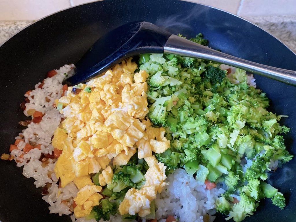 Add the chopped blanched broccoli and the scrambled eggs back into the wok. Sprinkle in the salt and drizzle the oyster sauce around the edges of the wok. Toss everything vigorously for about 1 minute until the seasonings evenly coat the rice and vegetables. Serve immediately.