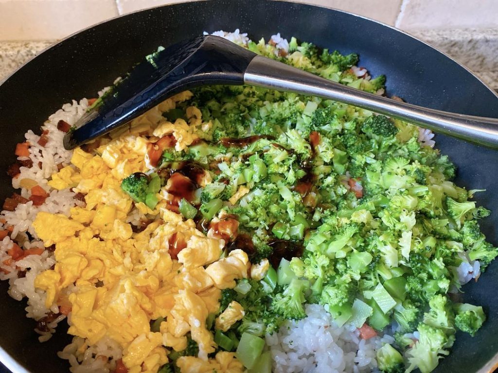 Add the chopped blanched broccoli and the scrambled eggs back into the wok. Sprinkle in the salt and drizzle the oyster sauce around the edges of the wok. Toss everything vigorously for about 1 minute until the seasonings evenly coat the rice and vegetables. Serve immediately.