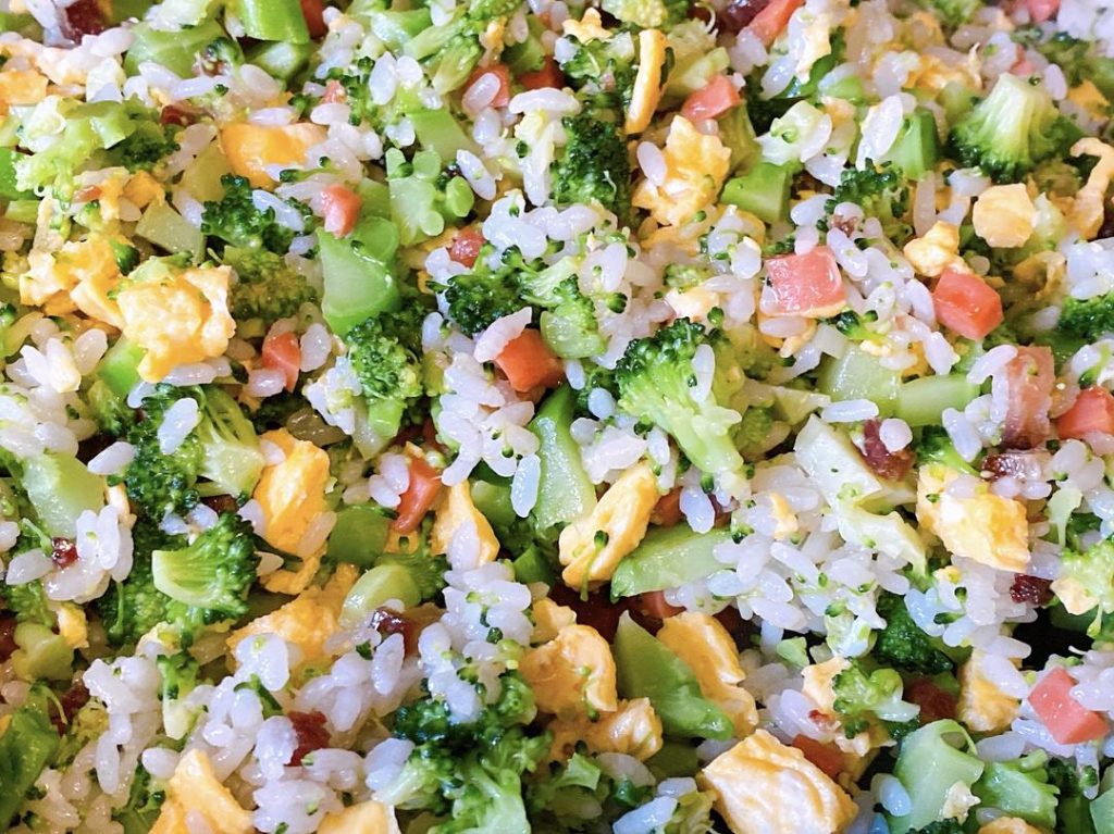 Add the chopped blanched broccoli and the scrambled eggs back into the wok. Sprinkle in the salt and drizzle the oyster sauce around the edges of the wok. Toss everything vigorously for about 1 minute until the seasonings evenly coat the rice and vegetables. Serve immediately.