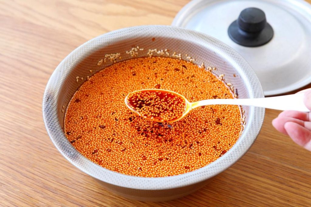 Transfer the oil (and the sludge of chilies at the bottom) into a heat-proof ceramic or stainless steel basin/jar. Cover with a lid immediately. Let it sit undisturbed for 24 hours (or at least overnight).