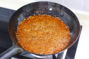 Add Sesame: Pour in the white sesame seeds. They will fizz vigorously.