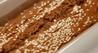 Bake Pour the batter into a lined or greased loaf pan or toast mold. Smooth the surface with a spatula. Pick up the pan and drop it firmly on the counter twice to release large air bubbles. Sprinkle raw white sesame seeds generously over the top. Bake at 340°F (170°C) for 30 to 35 minutes.