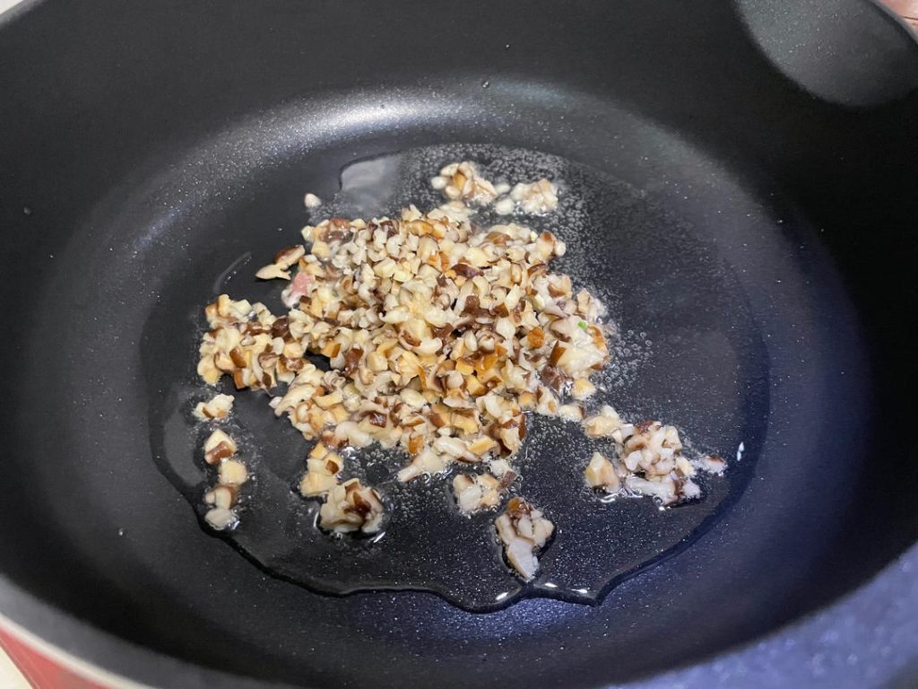 Pre-cook aromatics: Heat 1 tablespoon of oil in a skillet over medium heat. Sauté the minced shiitake mushrooms for 1 minute until fragrant. Add the minced bamboo shoots and stir-fry for another minute. Remove from heat and let cool.