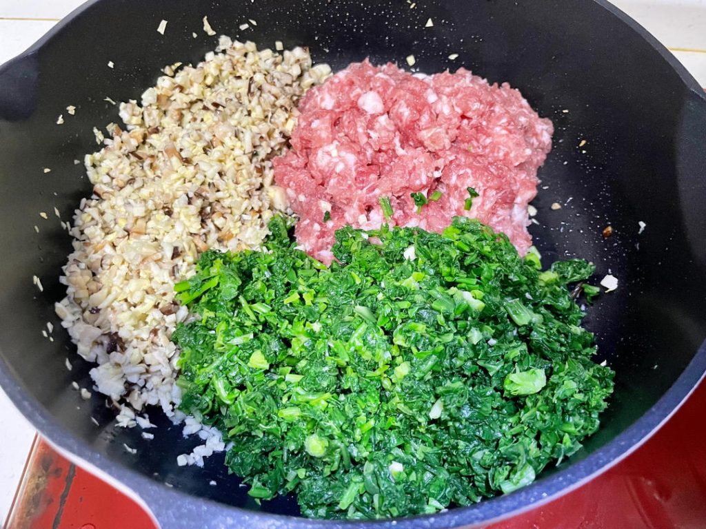 Mix the filling: In a large mixing bowl, combine the chopped greens, minced pork, and the cooled mushroom mixture. Add the egg, Shaoxing wine, salt, sugar, and seasoned oil.