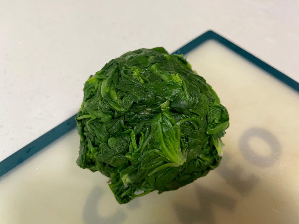 Drain and chop: Once cooled, squeeze the excess water out of the greens. Do not squeeze them completely bone-dry; leave a tiny bit of moisture. Finely chop the greens.