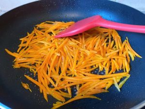 Fry the Carrots: Add the julienned carrots to the hot oil. Stir-fry for about 1 to 2 minutes. Why? Frying the carrots first softens their texture and infuses the oil with beta-carotene, turning the oil a beautiful golden hue.