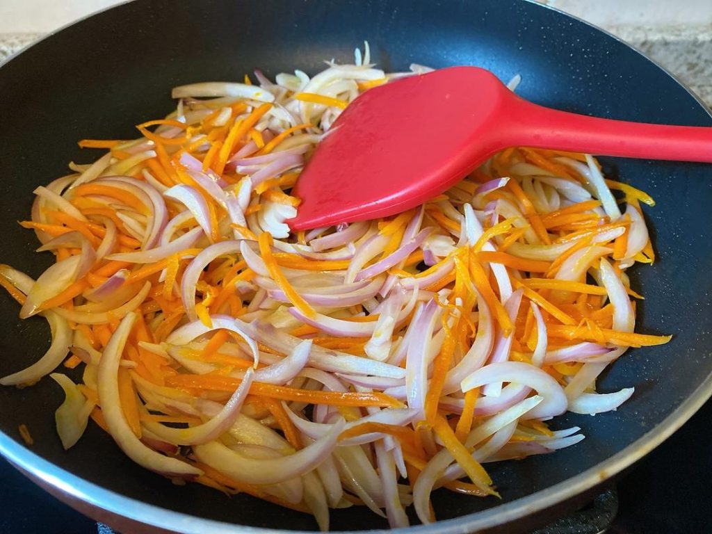 Add the Onions: Toss in the sliced onions. Continue to stir-fry for another 2 minutes until the onions become translucent and fragrant.