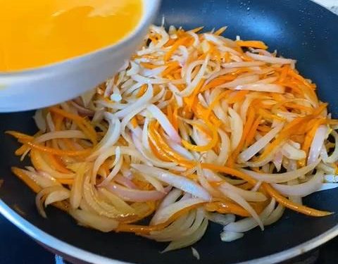 Pour in the Eggs: Pour the beaten eggs evenly over the vegetable mixture. Crucial step: Do not flip or stir immediately. Let the mixture sit undisturbed for about 15 to 20 seconds.