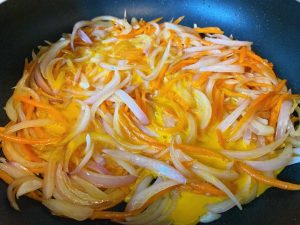 Pour in the Eggs: Pour the beaten eggs evenly over the vegetable mixture. Crucial step: Do not flip or stir immediately. Let the mixture sit undisturbed for about 15 to 20 seconds.