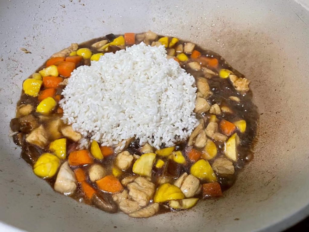 Season and Mix: Pour in 1 tablespoon of light soy sauce and a splash of dark soy sauce. Add the drained, soaked rice into the wok. Turn off the heat and mix everything thoroughly.