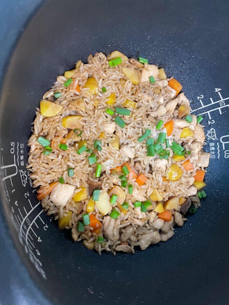 Garnish and Serve: Once the rice cooker chimes, open the lid and fluff the rice gently with a paddle. Garnish with freshly chopped scallions before serving.