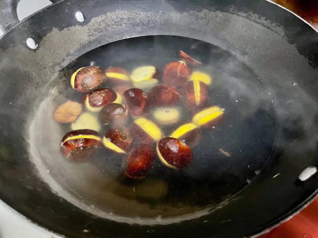 Meanwhile, prepare the chestnuts. If using fresh raw chestnuts, cut them in half. Bring a pot of lightly salted water to a boil. Boil the chestnuts for 2 minutes, then carefully peel off the hard shell and inner skin. Dice the peeled chestnuts.
